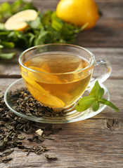 Cup with green tea on wooden background