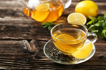 Cup with green tea and teapot 