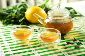 Cup with green tea and teapot 