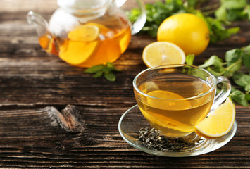 Cup with green tea and teapot 