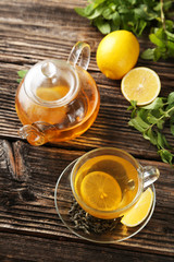 Cup with green tea and teapot 