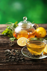 Cup with green tea and teapot 