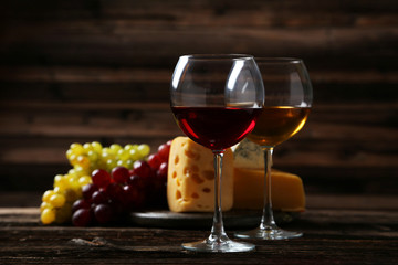 Glass of red wine, cheeses and grapes 