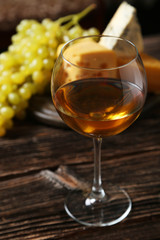 Glass of red wine, cheeses and grapes 