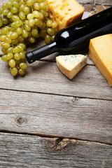 Glass of red and white wine, cheeses and grapes 