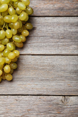 Green grape on grey wooden background