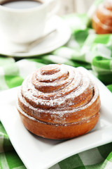 Freshly baked cinnamon buns on white plate