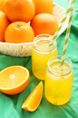 Orange juice in bottle and orange in basket 