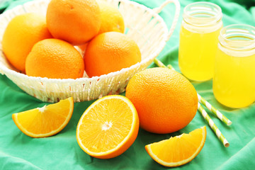 Orange juice in bottle and orange in basket 