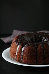 Chocolate bundt cake on wooden background