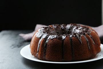 Chocolate bundt cake on wooden background