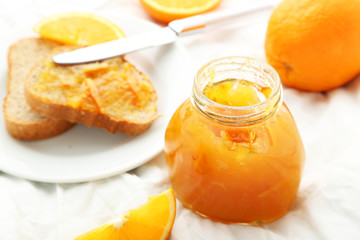 Orange juice in bottle and orange in basket 