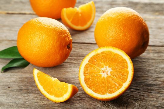 Fresh orange fruit on grey wooden background