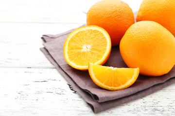 Ripe oranges on white wooden background