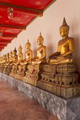 golden buddha statues in buddhist temple, bangkok