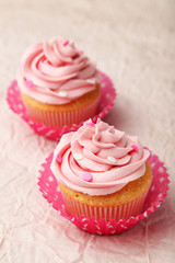 Tasty cupcakes on pink background
