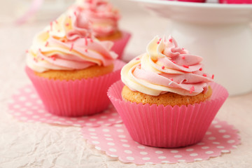 Tasty cupcake on pink background
