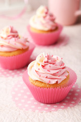 Tasty cupcakes on pink background