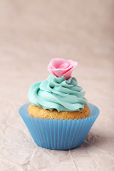 Tasty cupcake on pink background