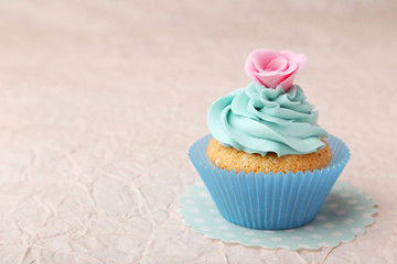 Tasty cupcake on pink background