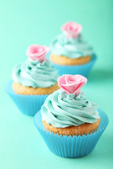 Tasty cupcake on green background