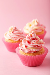 Tasty cupcake on pink background