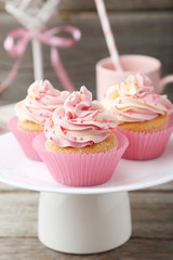 Tasty cupcake on grey wooden background