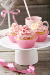 Tasty cupcake on grey wooden background