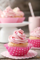 Tasty cupcake on grey wooden background