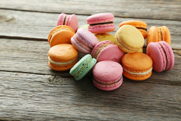 French colorful macarons on grey wooden background