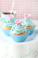 Tasty cupcake on white wooden background