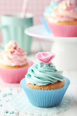 Tasty cupcake on white wooden background