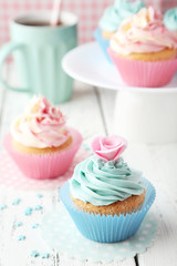 Tasty cupcake on white wooden background