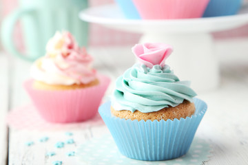 Tasty cupcake on white wooden background