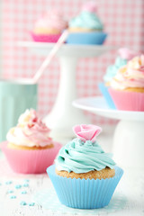 Tasty cupcake on white wooden background