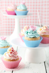 Tasty cupcake on white wooden background
