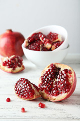 Delicious pomegranate fruit on white wooden background