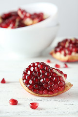 Delicious pomegranate fruit on white wooden background