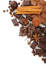 Dark chocolate bar with coffee beans and cinnamon on white backg