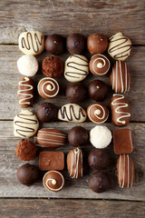 Chocolates on grey wooden background