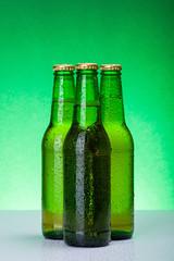 Three wet blank beer bottles