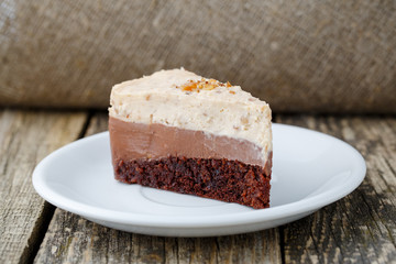 Tasty nuts cake on wooden background.