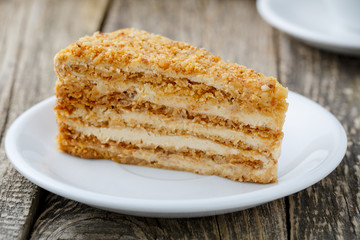 Tasty honey cake on wooden background.