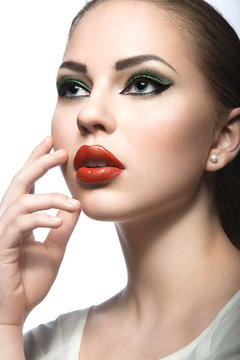 Beautiful woman with evening make-up, red lips. Beauty face. Picture taken in the studio on a white background.