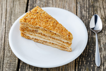 Tasty honey cake on wooden background.