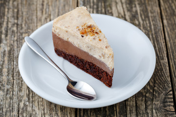 Tasty nuts cake on wooden background.
