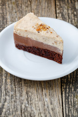 Tasty nuts cake on wooden background.