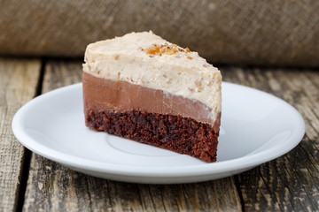 Tasty nuts cake on wooden background.