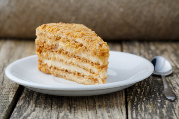 Tasty honey cake on wooden background.