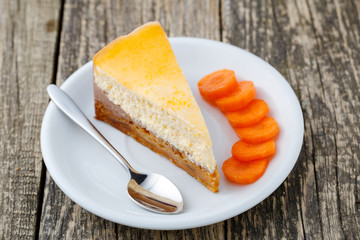 Sweet slice of carrot cake on white plate.
